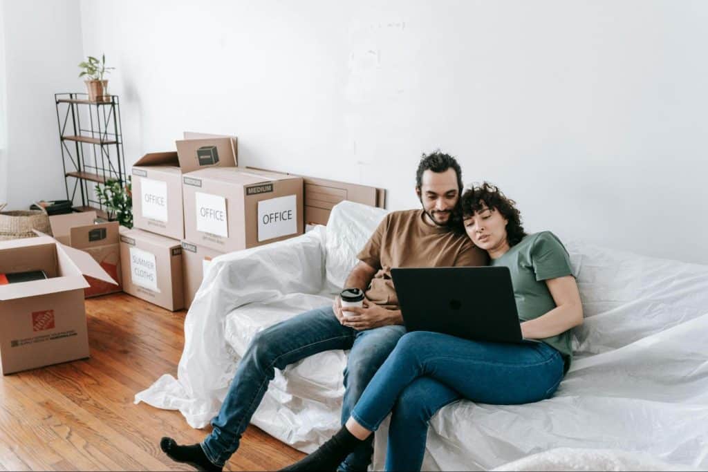 A man and woman checking laptop