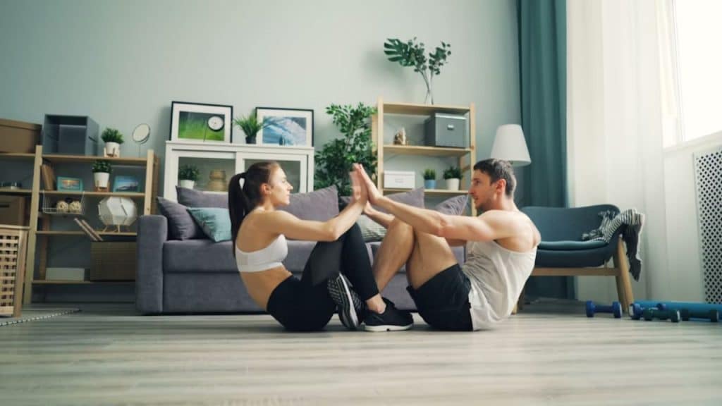 Husband and wife doing evening stretches to reduce tension