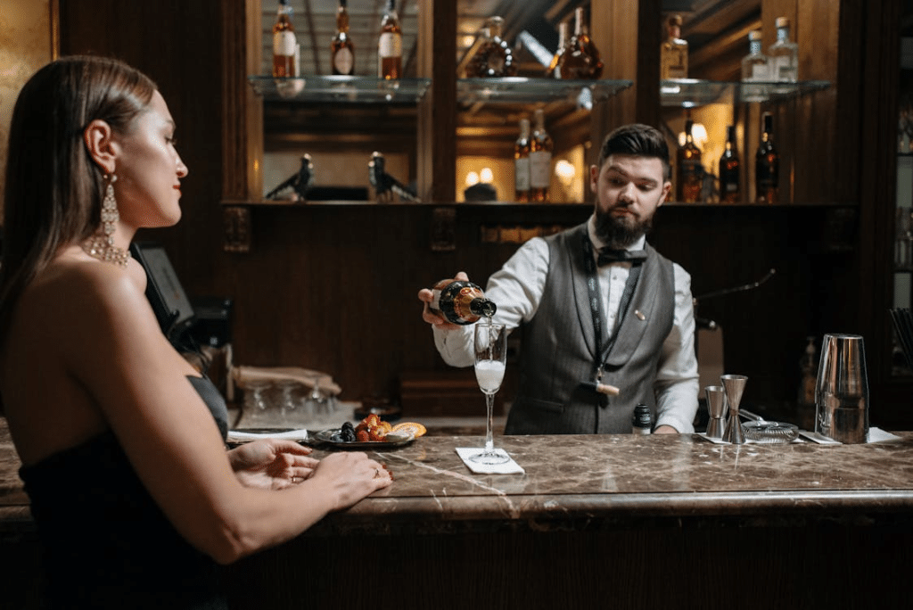 A Bartender Pouring Liquor Beverage on the Glass