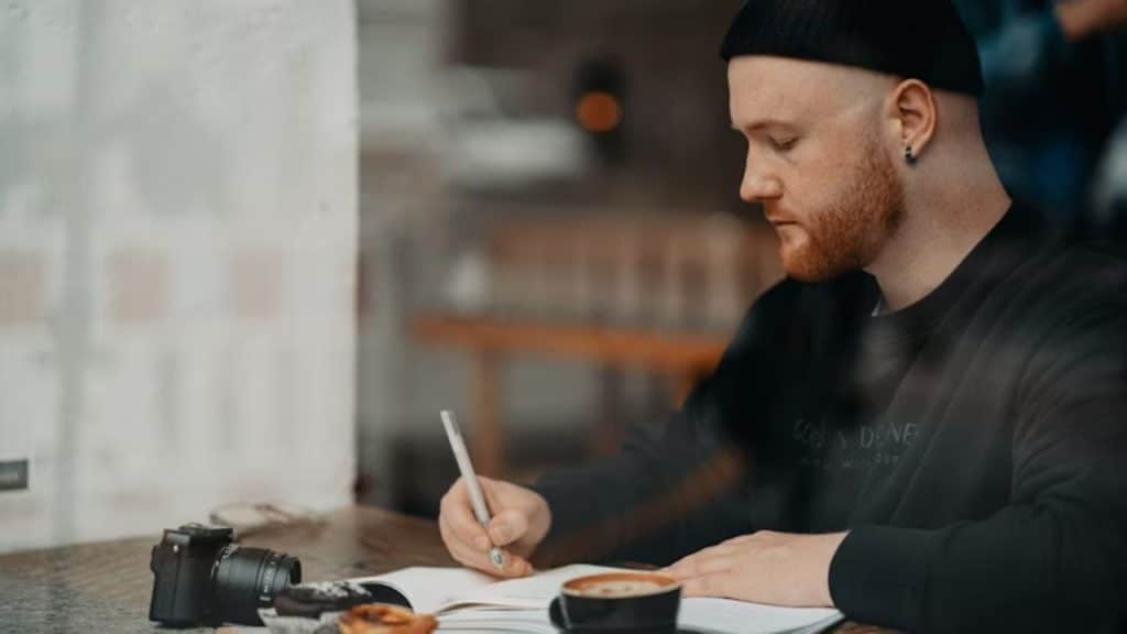 Man journaling or enjoying coffee alone in the morning