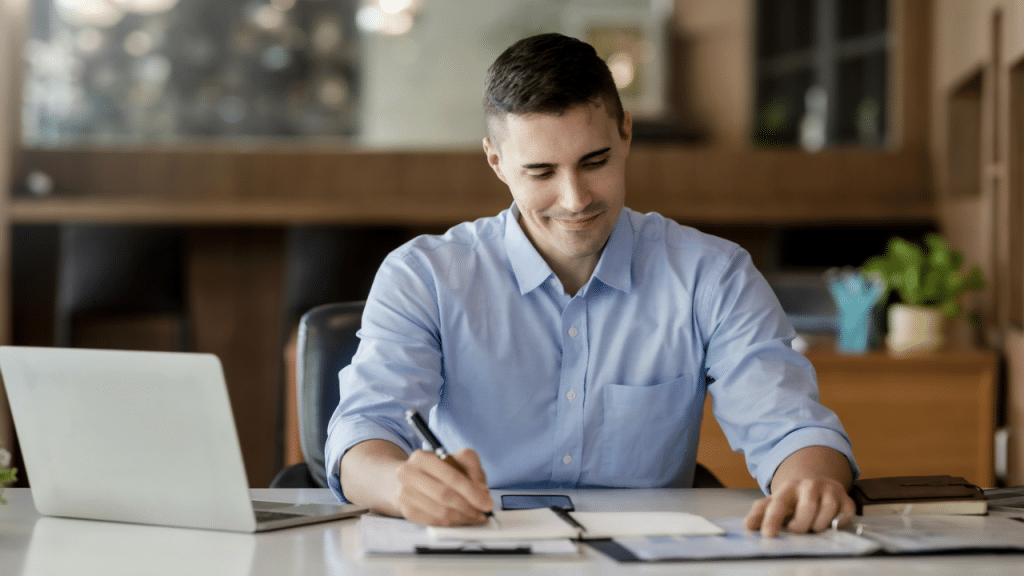A man studying and taking notes