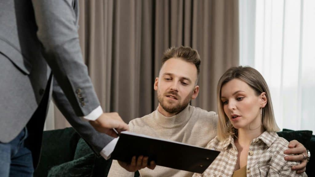 A couple reviewing documents with a professional in an office setting.