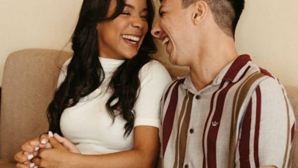 A couple laughing together at home