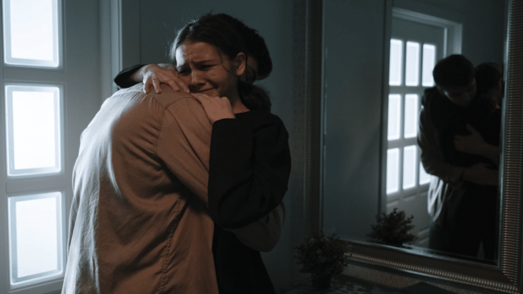 A man comforting his crying wife