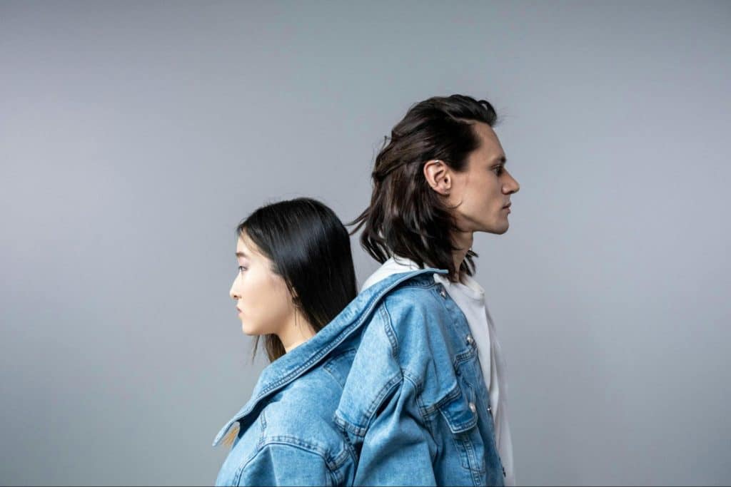 A man and woman facing away from each other
