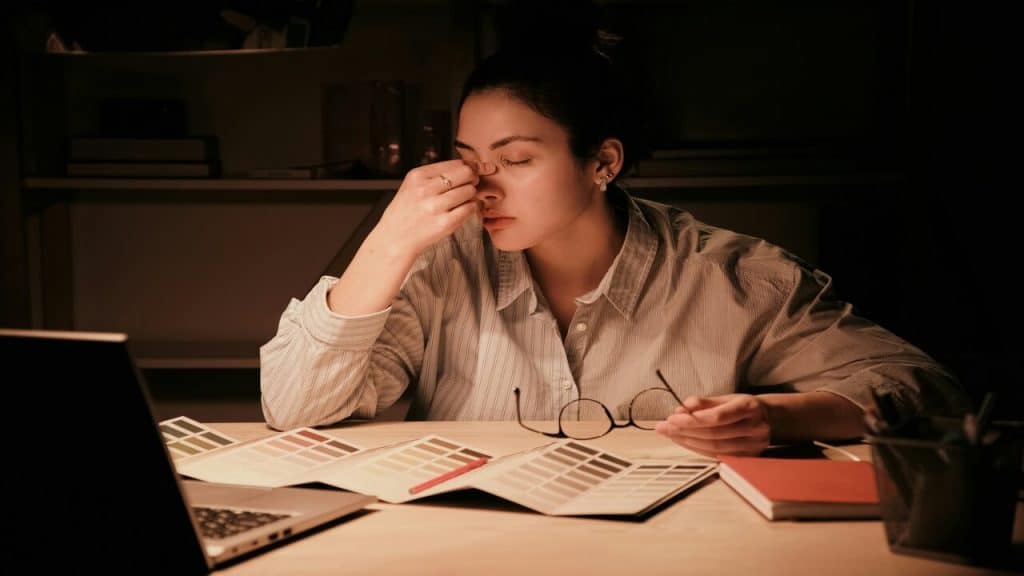 A woman looking stressed at work