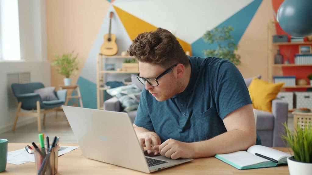 A man using his laptop at home