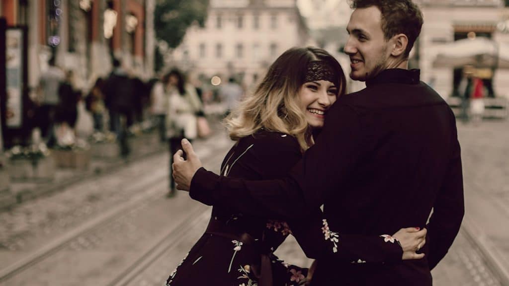 A smiling couple in love walking and smiling.