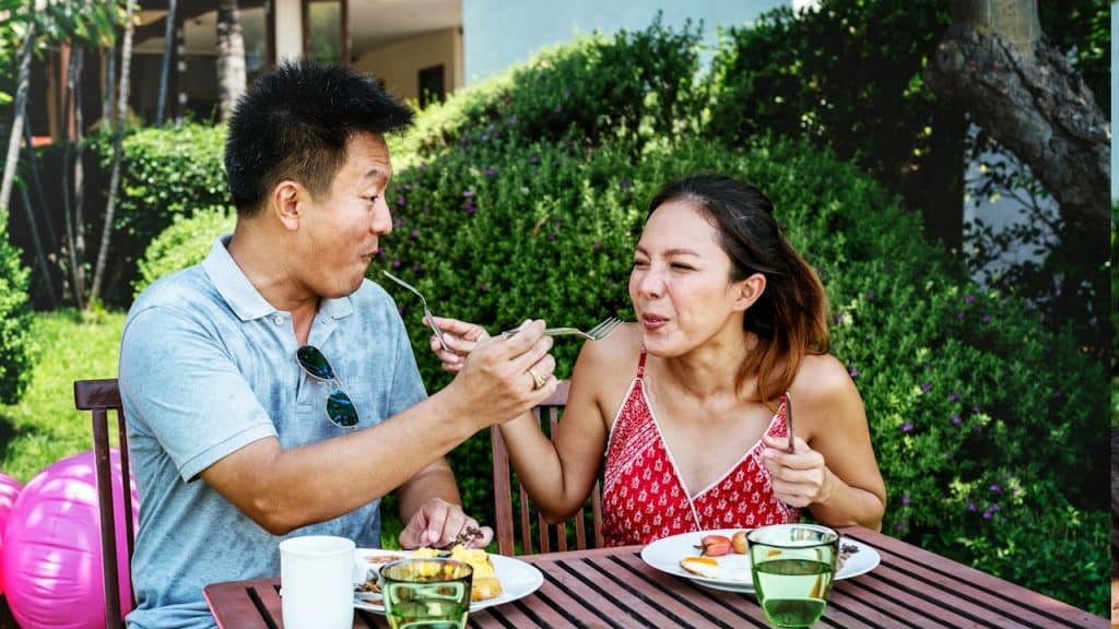 A couple eating a hotel breakfast.