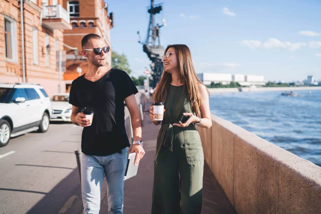 The couple is talking while exploring the city.