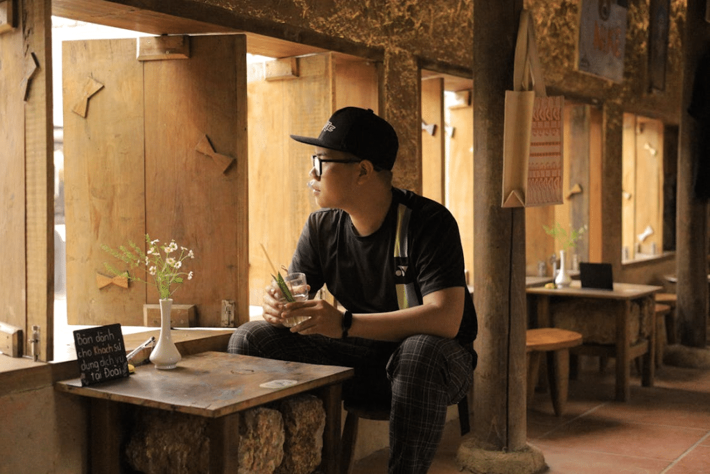Young Man Contemplating in Rustic Cafe Interior