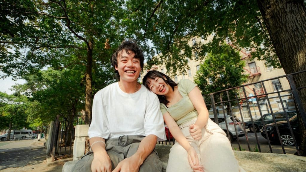A man and a woman are sitting on a bench.