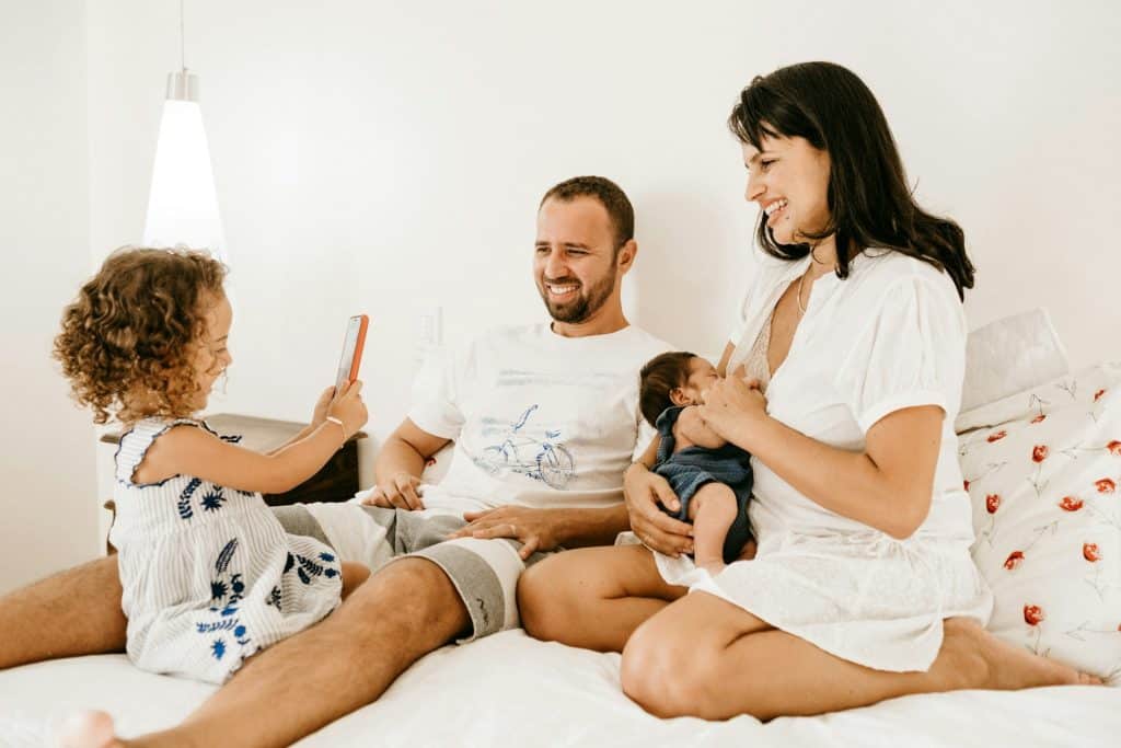 The family is spending time together in their bedroom.