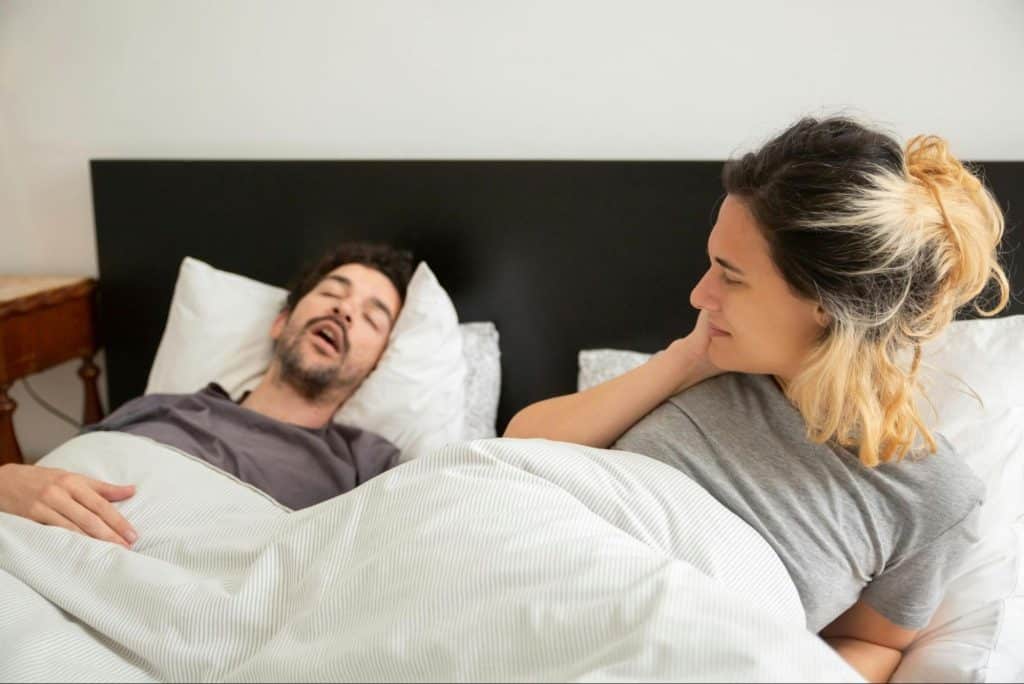 A man and woman at the bed