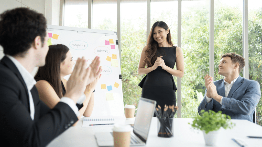 A woman being applauded at work