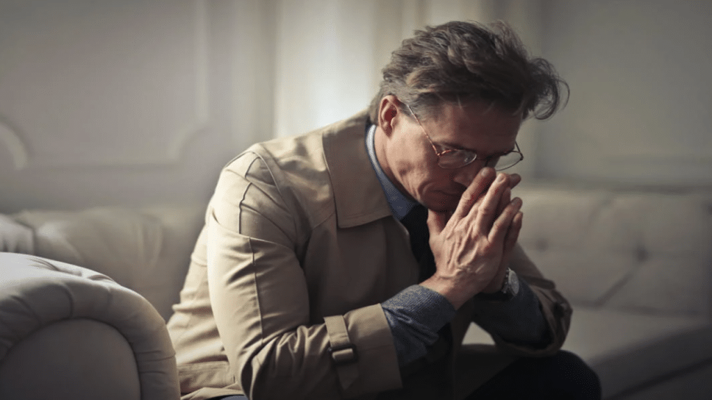 A man looking upset at home
