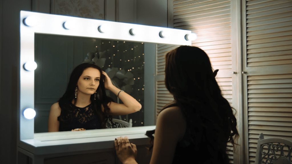 A woman looking at herself in the mirror