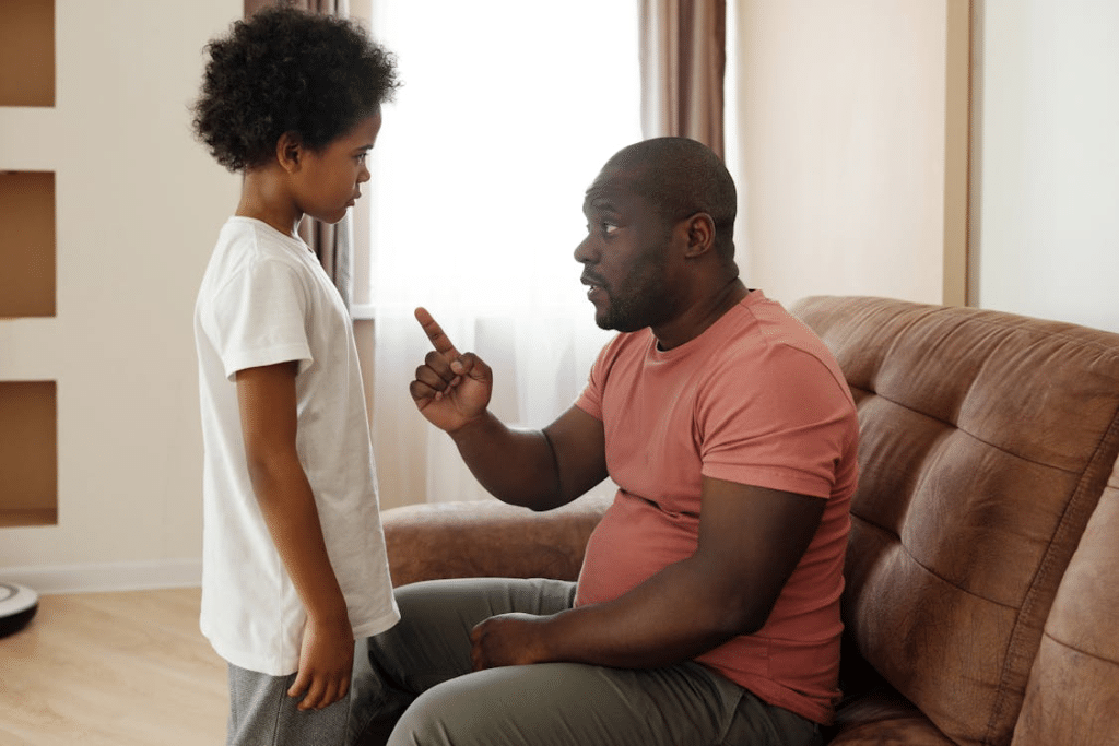 Frustrated black girl between arguing parents at table
