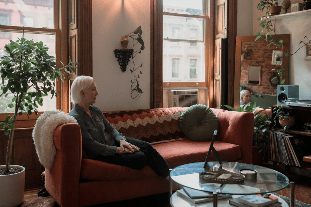 Woman Sitting on a Sofa looking Afar
