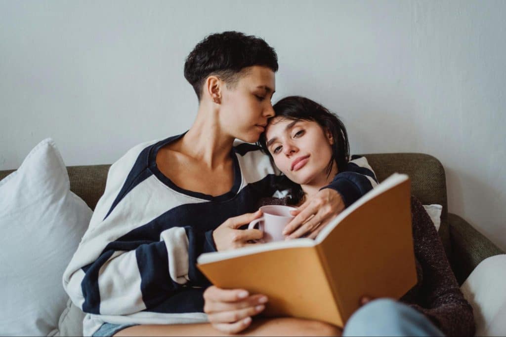 A man kissing a woman’s forehead 