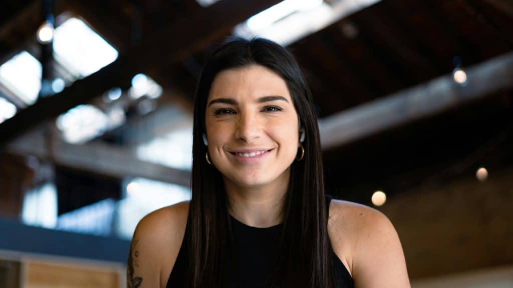 A brunette woman smiling at the camera.