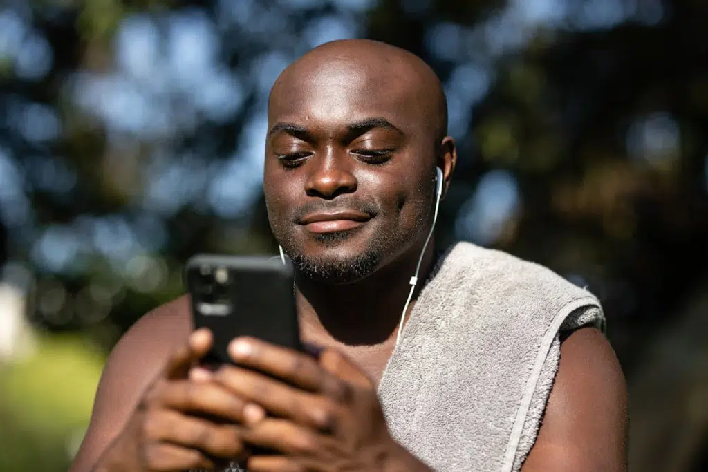 Man Listening to Music while Using a Mobile Phone