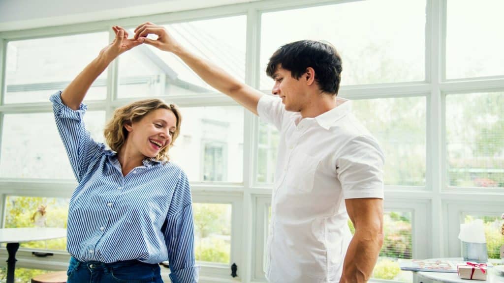 A couple dancing by the window