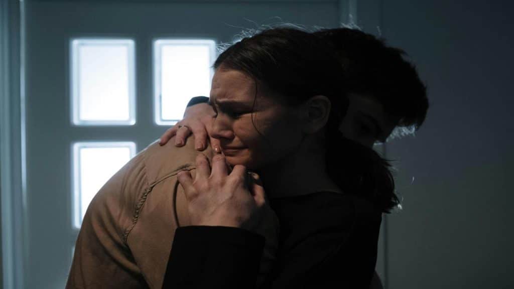 A man comforting his crying wife