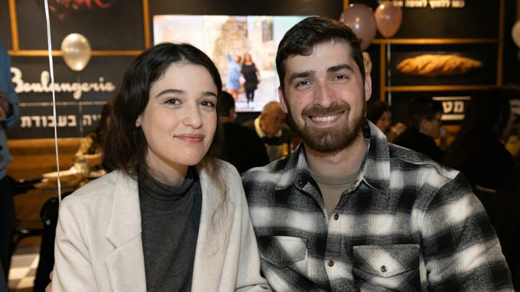 A young couple sitting together in a cafe.