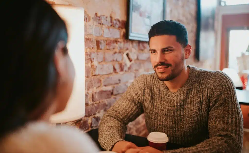 A man smiling at the woman