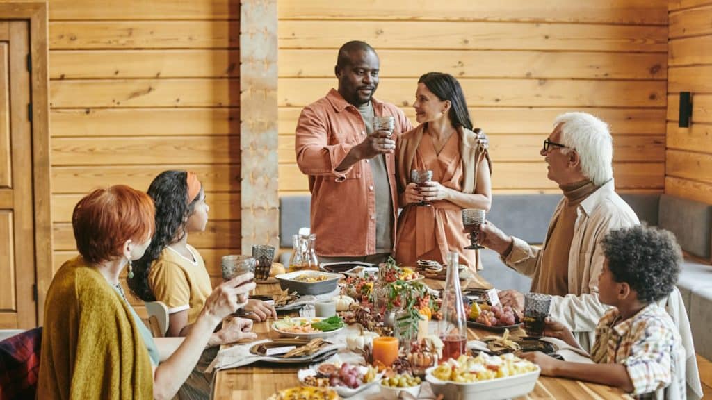 A family having dinner together and a couple making a toast.