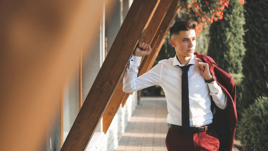A handsome young man in a suit posing for a picture.