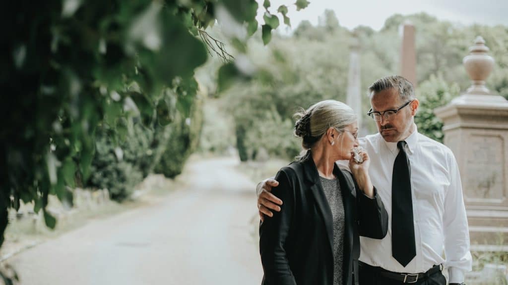Husband trying to comfort her wife due to her loss.