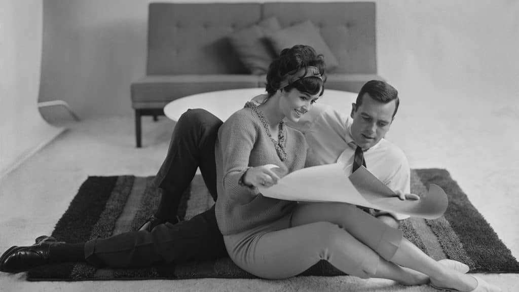 A man and a woman sitting on the floor.