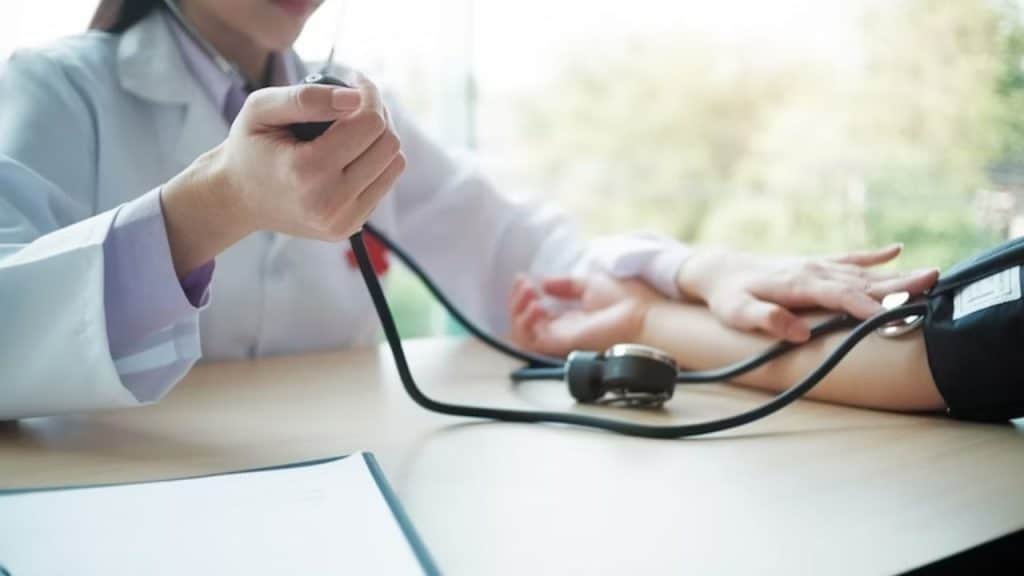 Man at a doctor’s office receiving a blood pressure check