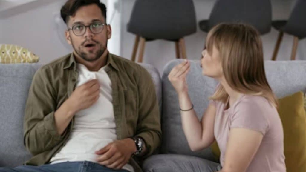 Man looking vulnerable as his partner reacts dismissively