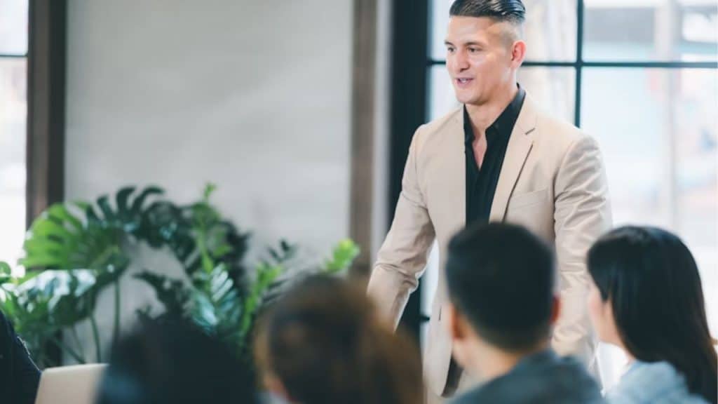 Man on a stage doing a presentation