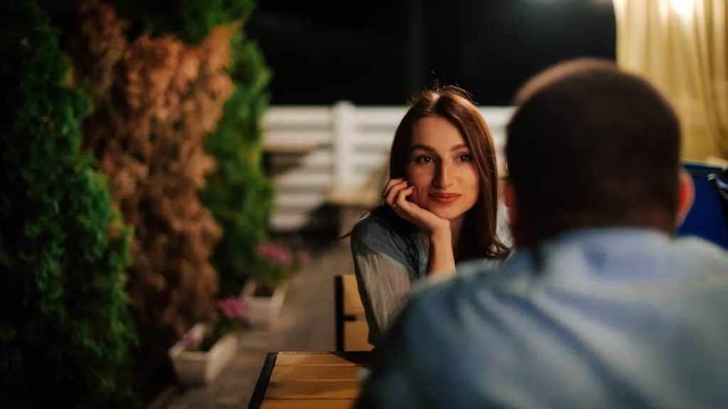 Woman sitting quietly beside her partner, looking thoughtful
