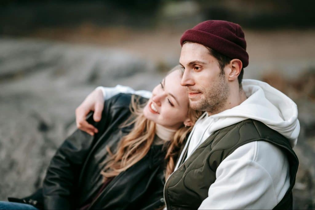 A woman leaning on a man’s shoulder