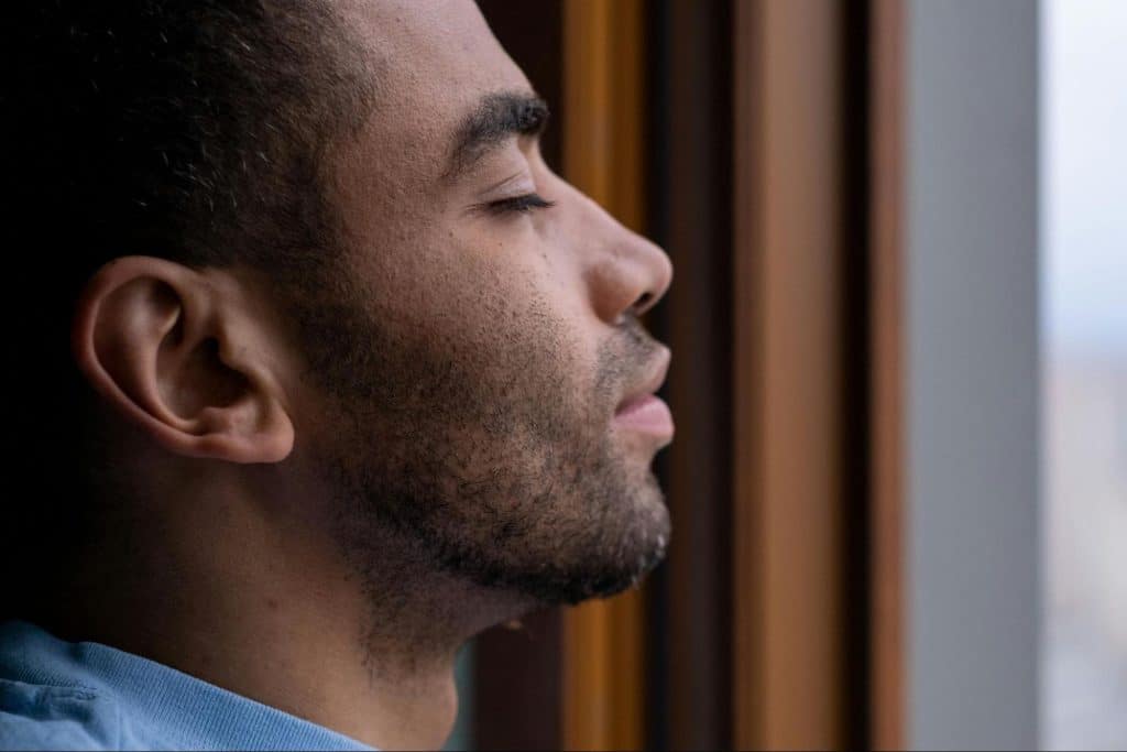 A man closing his eyes