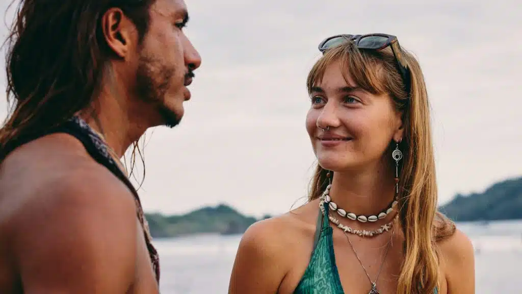 Close-up of a young couple in a beach or tropical setting.