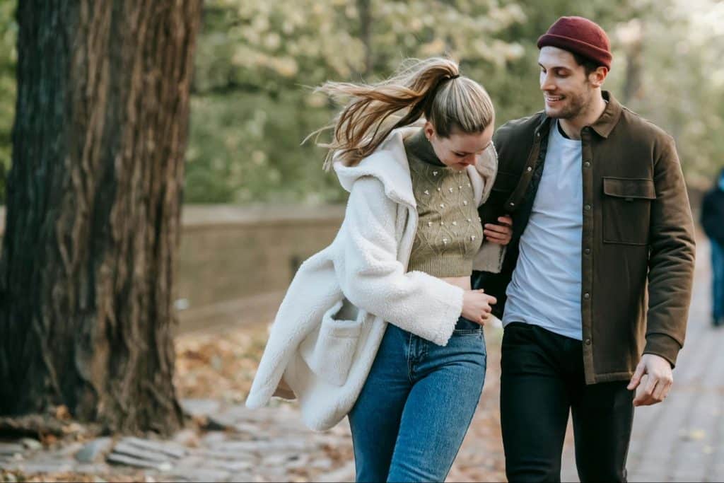 A man and woman walking at the park
