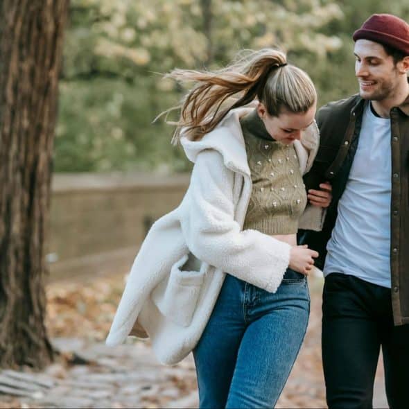 A man and woman walking at the park