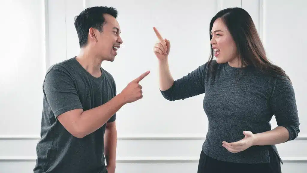 A man and a woman fighting with each other.