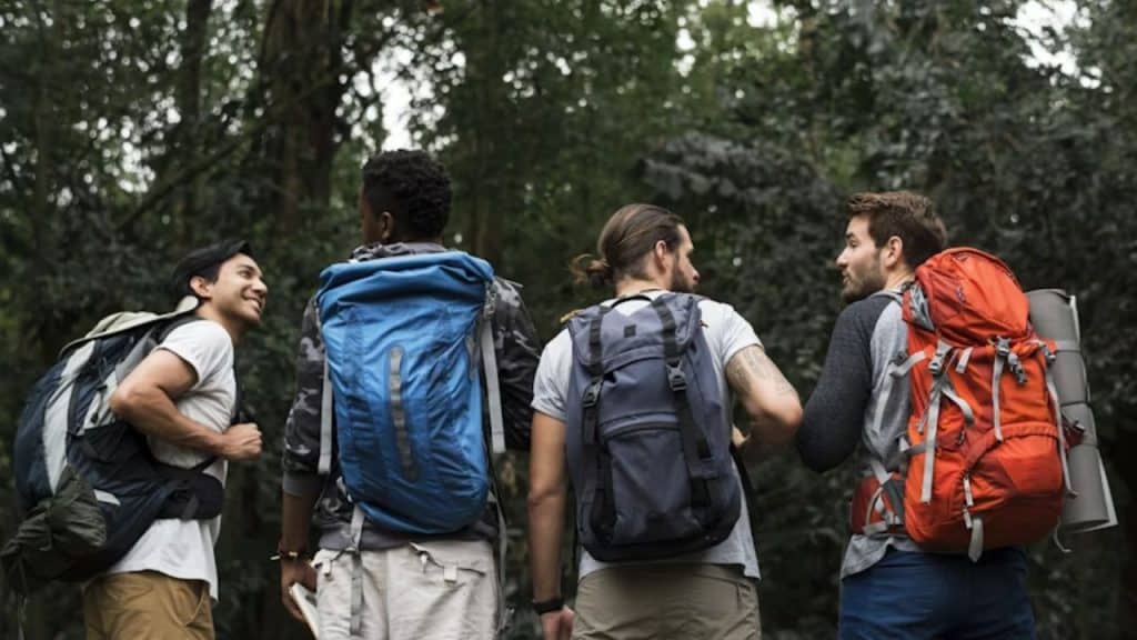 Group of friends hiking together, smiling and supportive