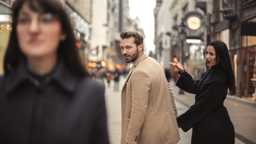 A man looking at another woman