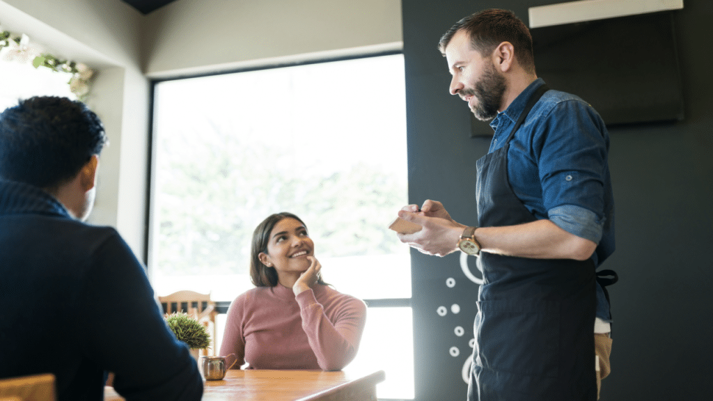 A couple talking to a waiter