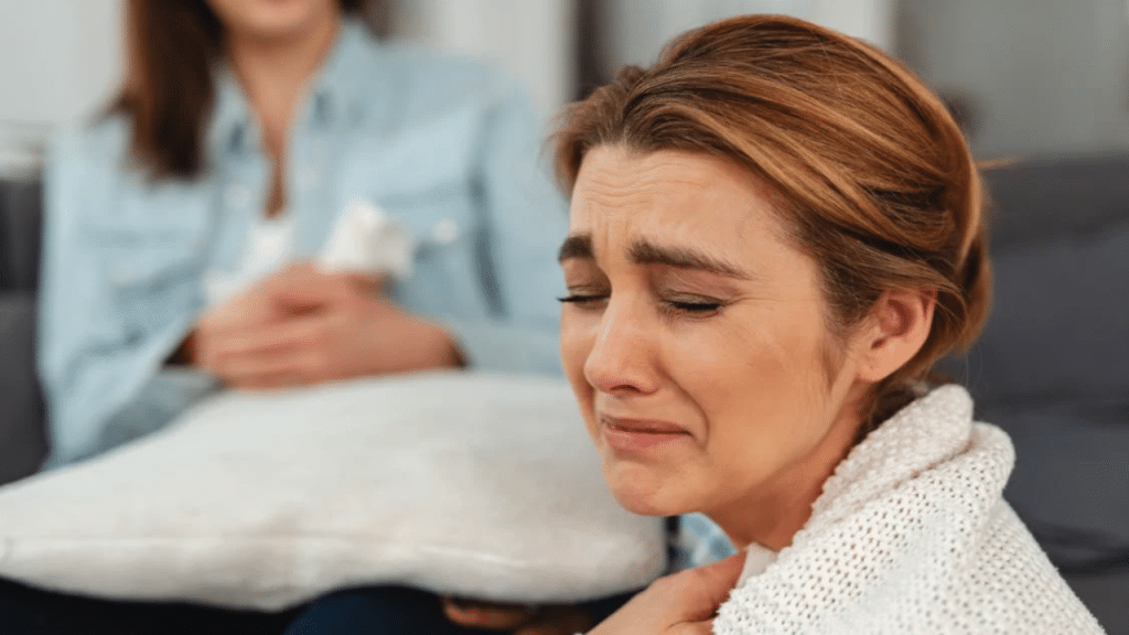 A woman crying while her friend looks on