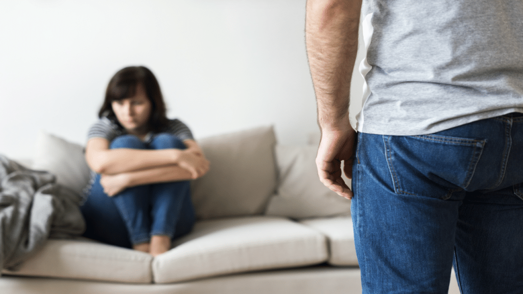 A woman looking scared at her husband