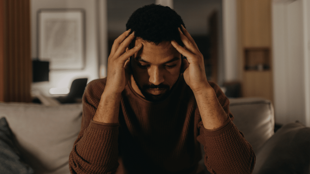 A man looking stressed at home